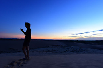 Fototapeta na wymiar Tourist in white sand dunes