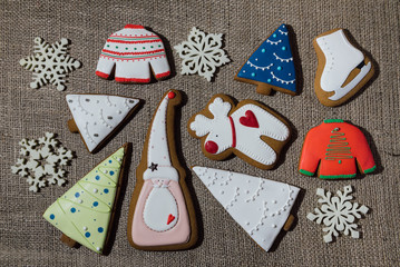 Christmas gingerbread cookies on burlap background. Deer, fir tr