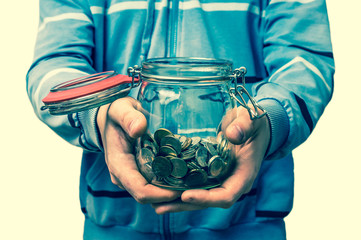 Man holding money jar with coins - retro style