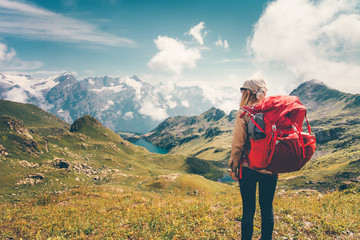 Woman with backpack enjoying mountains landscape view hiking Travel Lifestyle concept adventure vacations outdoor