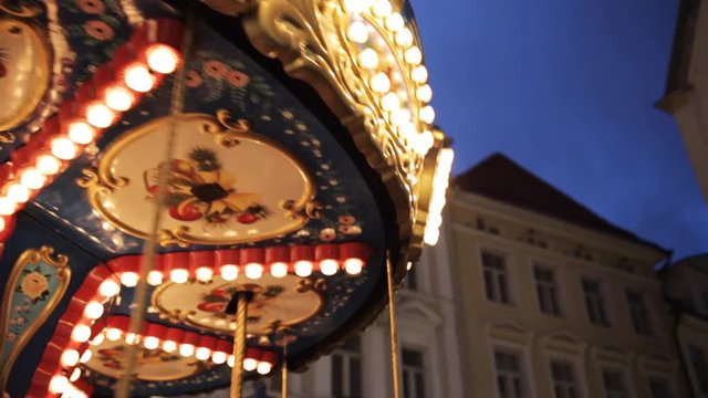 illuminated carousel in old city at night
