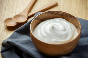 Fototapeta na wymiar Greek yogurt on wooden background