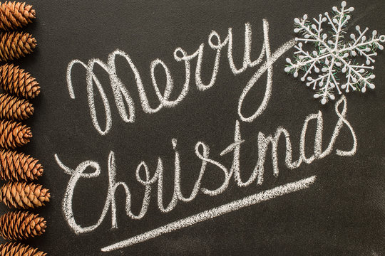  Merry Christmas written on a chalkboard concept happy new year.