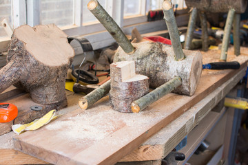 Making wooden reindeers from the logs in the shed, selective focus