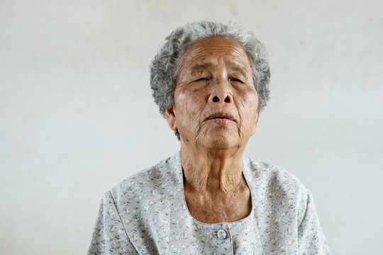 Protrait of senior asian woman on white background