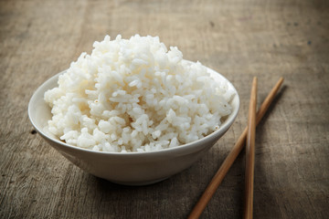 Japan rice with chopsticks on wooden background