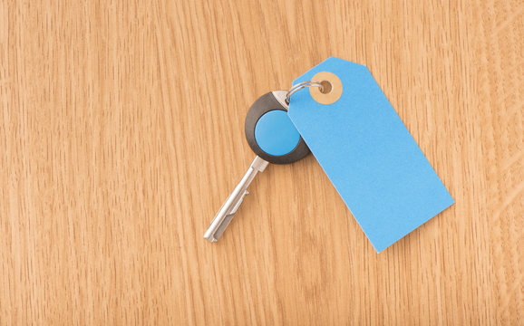 Modern key and blank label with copy space. Concept image of buying new property or home security.