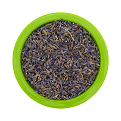 Bowl of lavender flower petals on a white background top view.