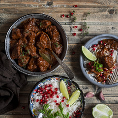Dinner table - braised beef stew and rice on a wooden rustic table. Top view