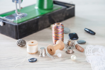 Fototapeta na wymiar Beads,thread and bobbins for needlework.Selective focus