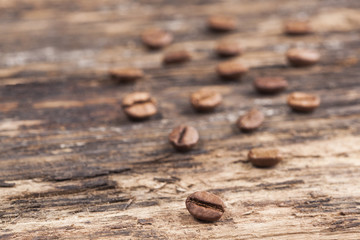 Coffee grains on grunge wooden background