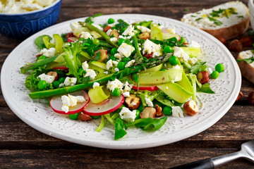Fresh Green Asparagus salad witch Goat Cheese, peas, radishe, zucchini, lettuce and Hazelnuts.