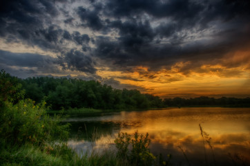 Fototapeta na wymiar Stormy Sunrise over a lake.