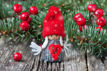 Cute christmas gnome dressed in red knitted clothes