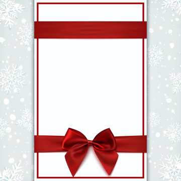 Blank greeting card with red ribbon and bow.