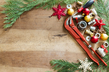 plumber  tools, fittings and Christmas decorations on wooden background