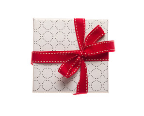 Gift box with red ribbon isolated on white