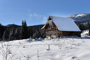 Mountain wooden chalet covered with fresh snow