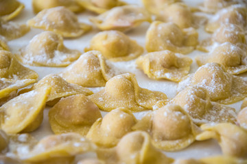 Fototapeta na wymiar Raw italian cappelletti, fresh homemade pasta stuffed with cheese and meat.