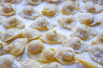 Raw italian cappelletti, fresh homemade pasta stuffed with cheese and meat.