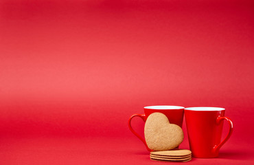 Red background with two cups and gingerbread