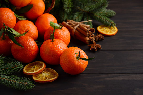 Fresh tangerine clementine with spices on dark wooden background, Christmas concept, selective focus, horizontal