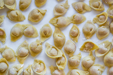Raw italian cappelletti, fresh homemade pasta stuffed with cheese and meat.