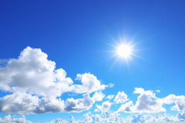 Naklejka na ściany i meble sun shines on blue sky with clouds