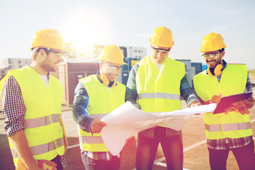 group of builders with tablet pc and blueprint