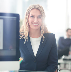 Young business woman standing with her collegues in background a