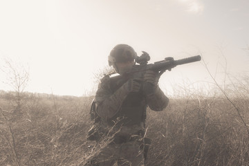 Airsoft soldiers in uniform on the battlefield running in fog