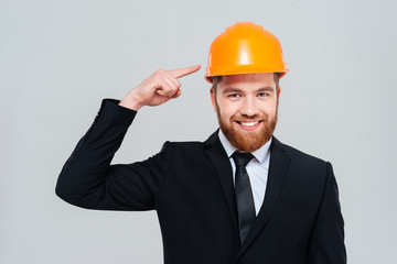 Engineer pointing at helmet
