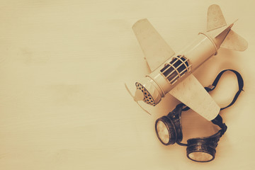 vintage toy plane and pilot glasses. Sepia style image