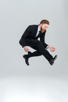 Full length young business man jumping