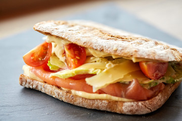 salmon panini sandwich on stone plate