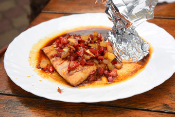 Cooked pike with vegetables in soy sauce