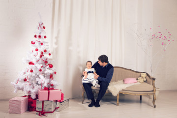 Naklejka premium happy family father and child baby daughter with Christmas tree