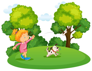 Obraz na płótnie Canvas Girl playing with pet dog in park