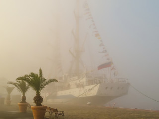 Old sailing ship at the mooring in fog. Varna, Bulgaria