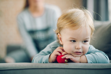 Mom playing with her son in cosy living room