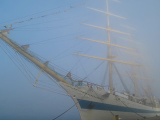 Fototapeta premium Old sailing ship at the mooring in fog. Varna, Bulgaria