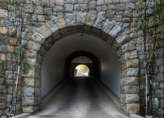 Fototapeta na wymiar Stone tunnel with light coming from the exit.Business concept