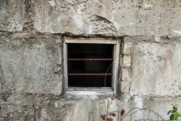 Old window in cement foundation, old Construction close-up.