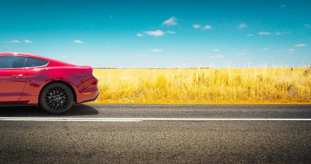 Wall murals Fast cars Sport car .parked on road side with field of golden wheat background .