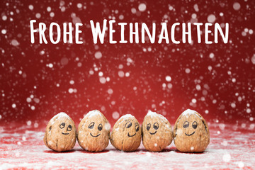 Christmas card - Cute Walnut family with drawn faces and snowfall