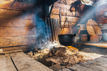 Vintage bowler for cooking food inside the old wooden house in the mountains. Authentic housing...