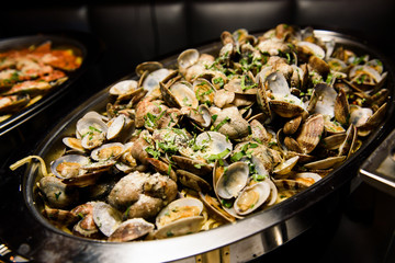 Mussels lie on big steel dish