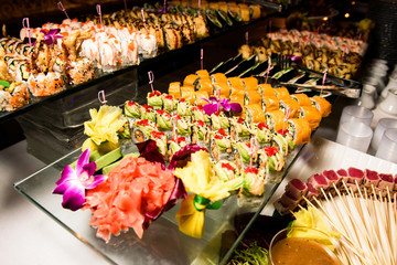 Tasty sushi served on large glass plates