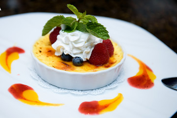 Cheese dessert with berries on white plate