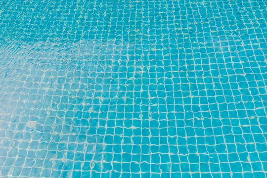 Swimming pool with turquoise blue tiles can be used as background